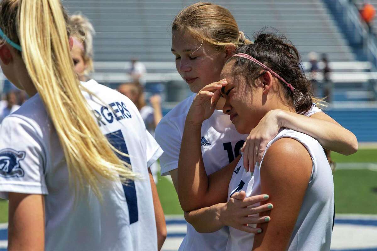 Boerne Champion defender Sam Weltens embraces forward Nevaeh Garris after falling to Grapevine 6-3 during a Class 5A girls soccer semifinal in Georgetown, Thursday, Apr., 14, 2022.