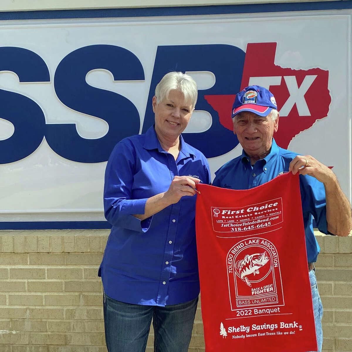 Shelby Savings Bank of Hemphill is a co-sponsor of the fishing towels.  Pictured is Dee Schrieber, Branch Manager with TBLA BU Coordinator Ted Dove.