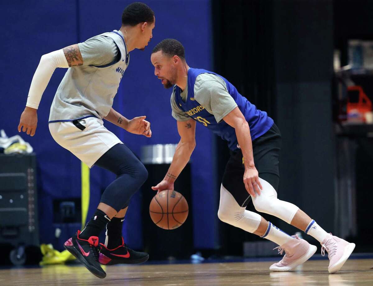 Golden State Warriors’ Stephen Curry dribbles against Juan Toscano-Anderson during practice at Chase Center in San Francisco, Calif, on Thursday, April 14, 2022.