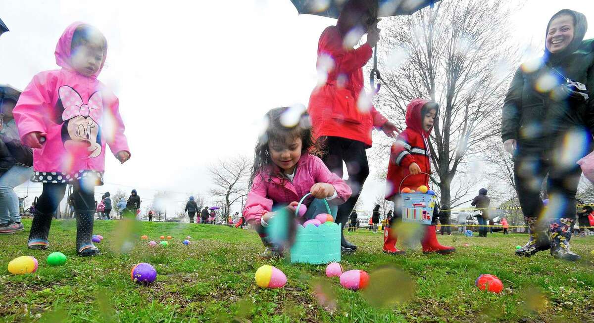Kids scramble to collect eggs from an Easter Egg Patch during a community Easter egg hunt at Calf Pasture Beach on Saturday, April 20, 2019 in Norwalk. The event was hosted by the Word Alive Bible Church of Norwalk and featured over 10,000 eggs filled with surprises.