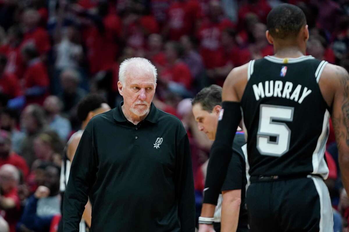 San Antonio Spurs head coach Gregg Popovich walks on the court after calling a timeout in the second half of an NBA play-in basketball game against the New Orleans Pelicans in New Orleans, Wednesday, April 13, 2022. The Pelicans won 113-103. (AP Photo/Gerald Herbert)