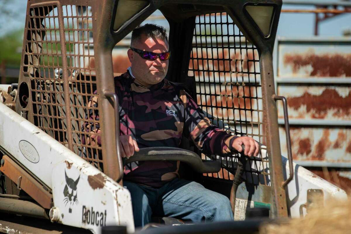 Pat Bierschwale uses a skid steer while working on his Katerra Exotics ranch, Thursday, April 7, 2022, in Katy.