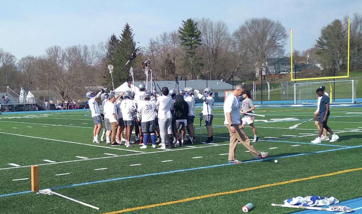 The co-op boys lacrosse team between the two high schools of Stratford, Conn. -- Stratford and Bunnell -- huddles before the second half of an 18-8 win over Notre Dame-Fairfield on April 14, 2022, at Bunnell.
