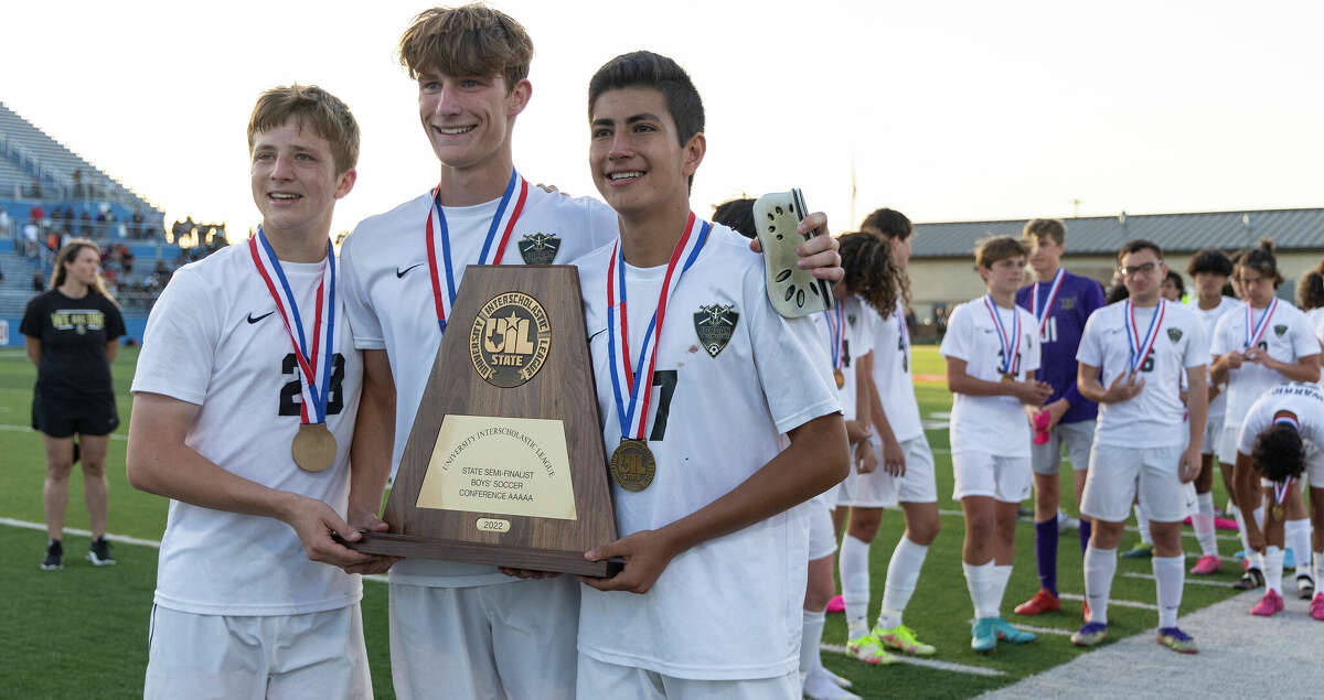Jordan defender Pierce Sanchez, defender Ben Bucic and midfielder Ryan Armijo pose with the third place trophy after falling to Dripping Springs 1-0 during a Class 5A boys soccer semifinal in Georgetown, Thursday, Apr., 14, 2022.