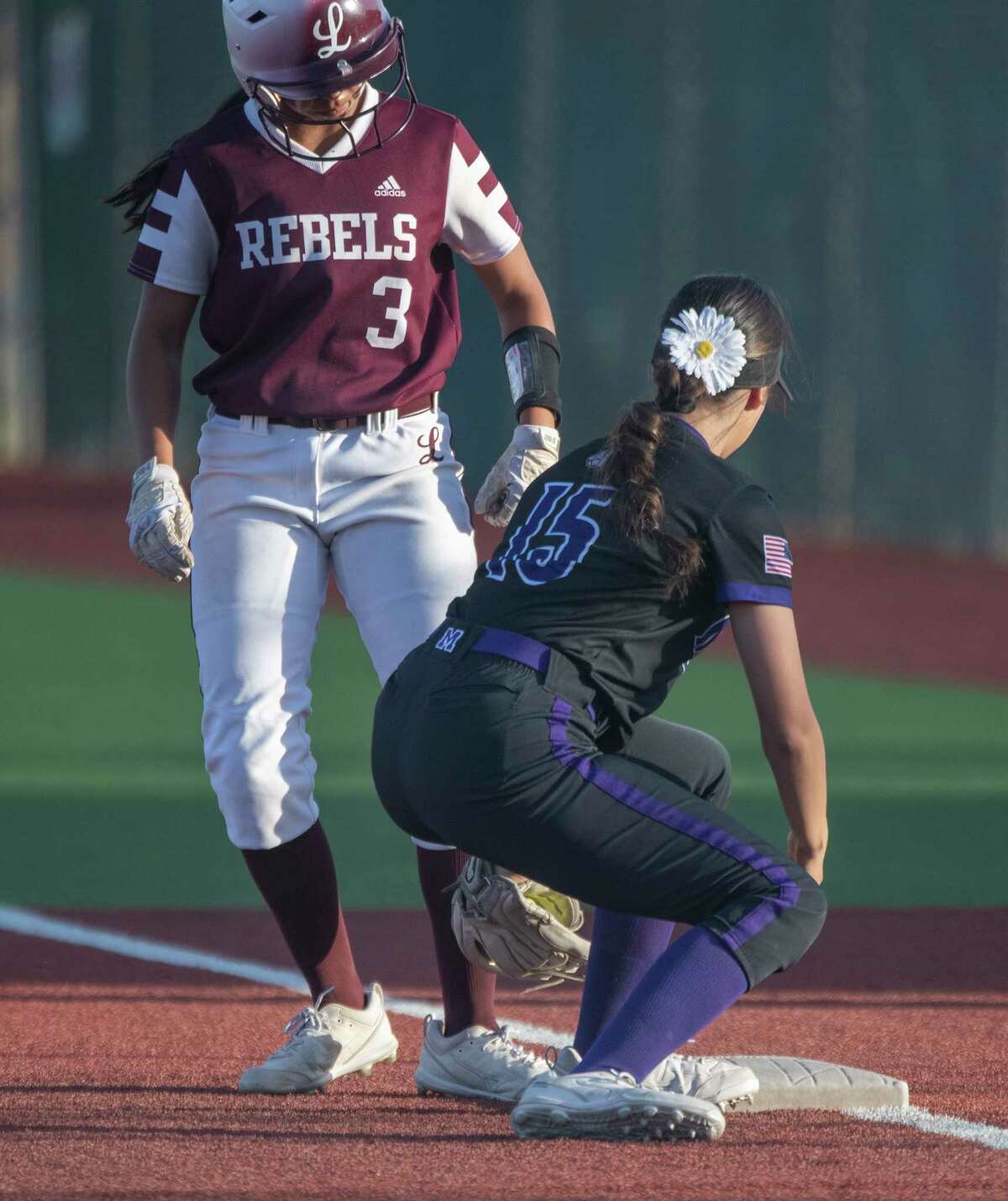 Legacy High's Marisa Calzada easily makes it back to first as Midland High's Liliana Garza tries to tag her on a throw from home 04/14/2022 at Martin Field Tim Fischer/Reporter-Telegram