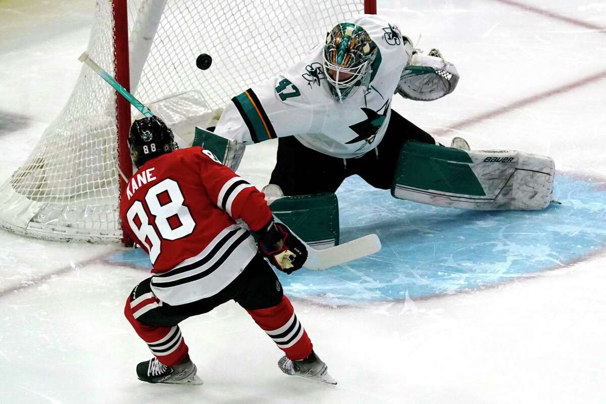 San Jose Sharks goaltender James Reimer, right, cannot save a goal by Chicago Blackhawks right wing Patrick Kane, left, during the first period of an NHL hockey game in Chicago, Thursday, April 14, 2022. (AP Photo/Nam Y. Huh)