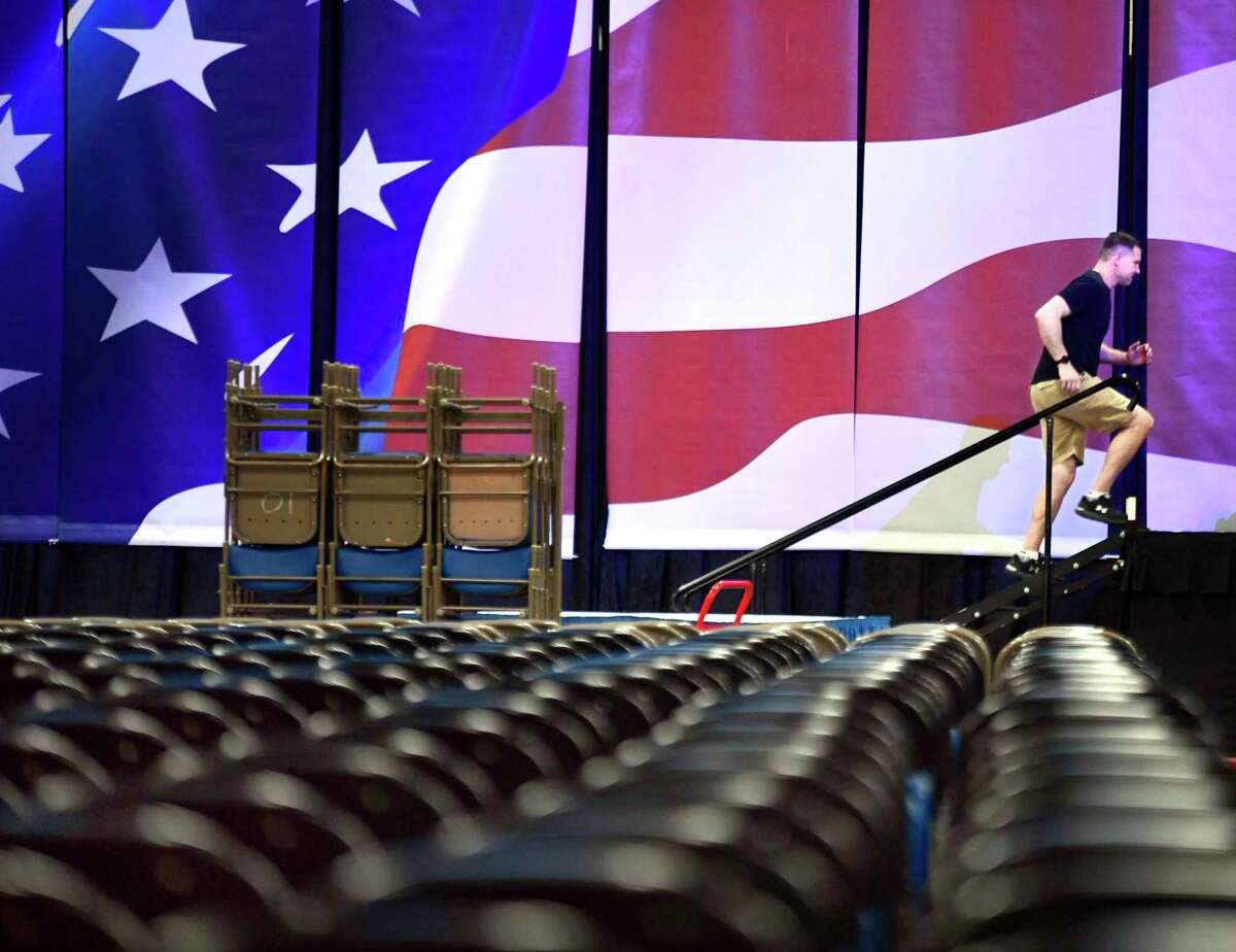 Jeremy Brech, of Jer Events, based in Sioux Falls, S.D., walks onto the stage to work on the lighting and sound before the start of the state convention of the North Dakota Republican party Friday, April 1, 2022 at the Bismarck Event Center in Bismarck, N.D.