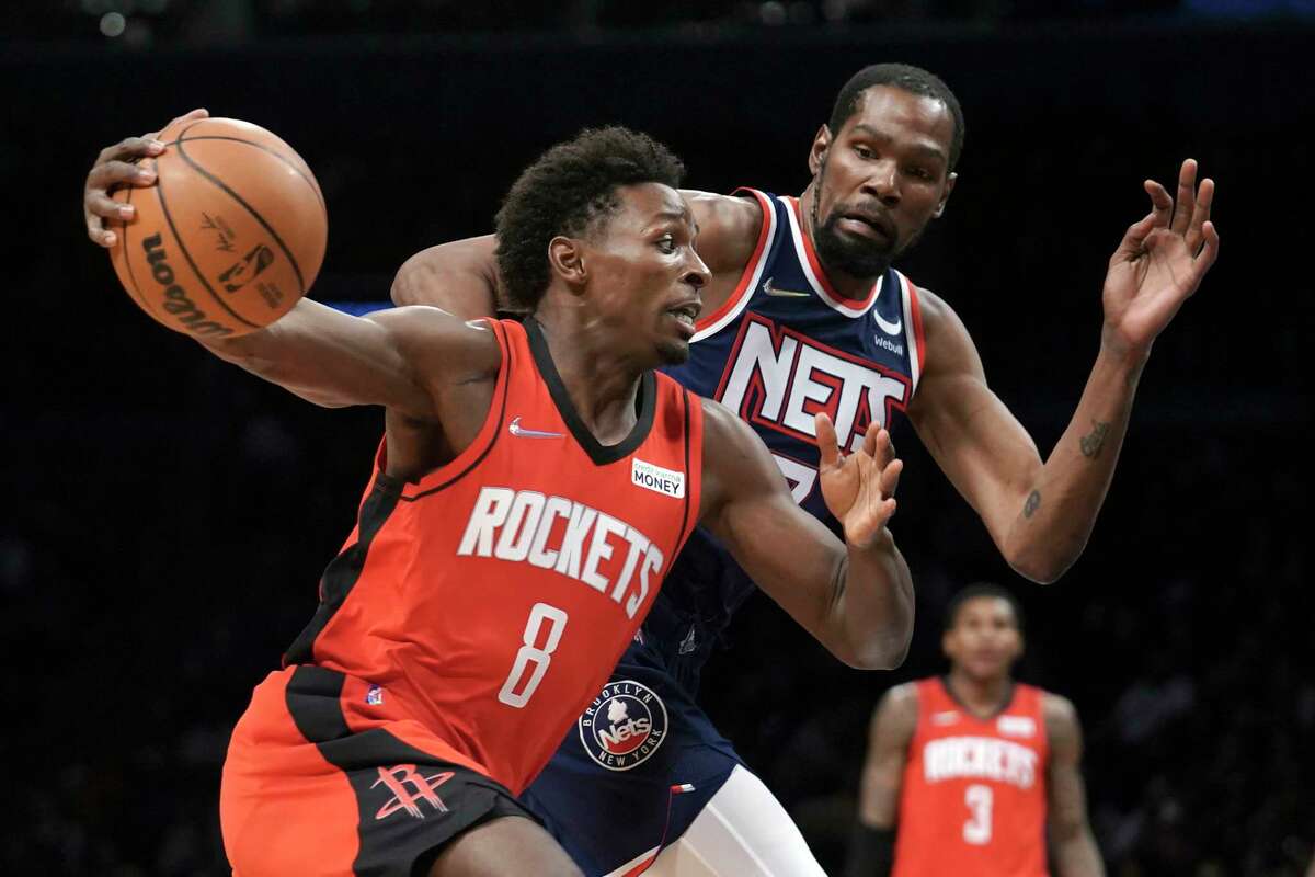 Houston Rockets forward Jae'Sean Tate (8) drives against Brooklyn Nets forward Kevin Durant (7) during an NBA basketball game, Tuesday April 5, 2022, in New York. (AP Photo/Bebeto Matthews)