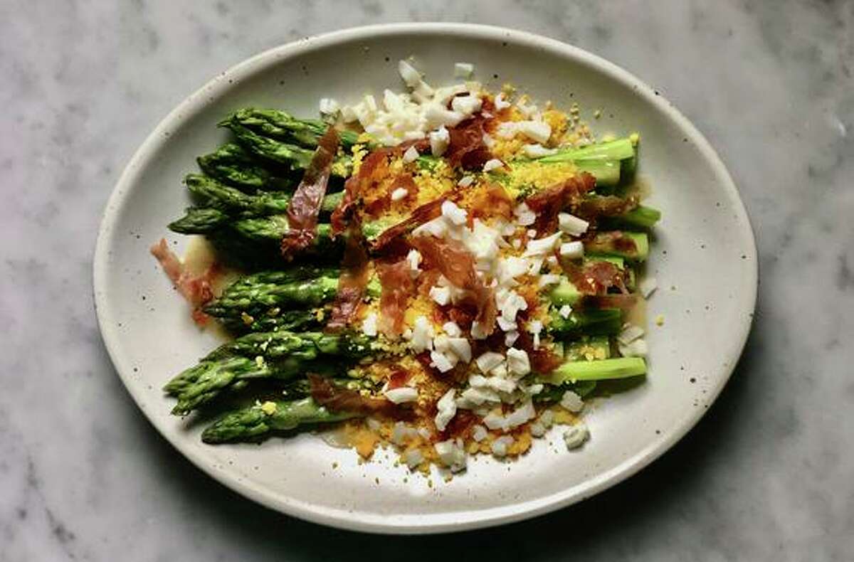 Asparagus gets topped with a mustardy vinaigrette in this spring recipe.