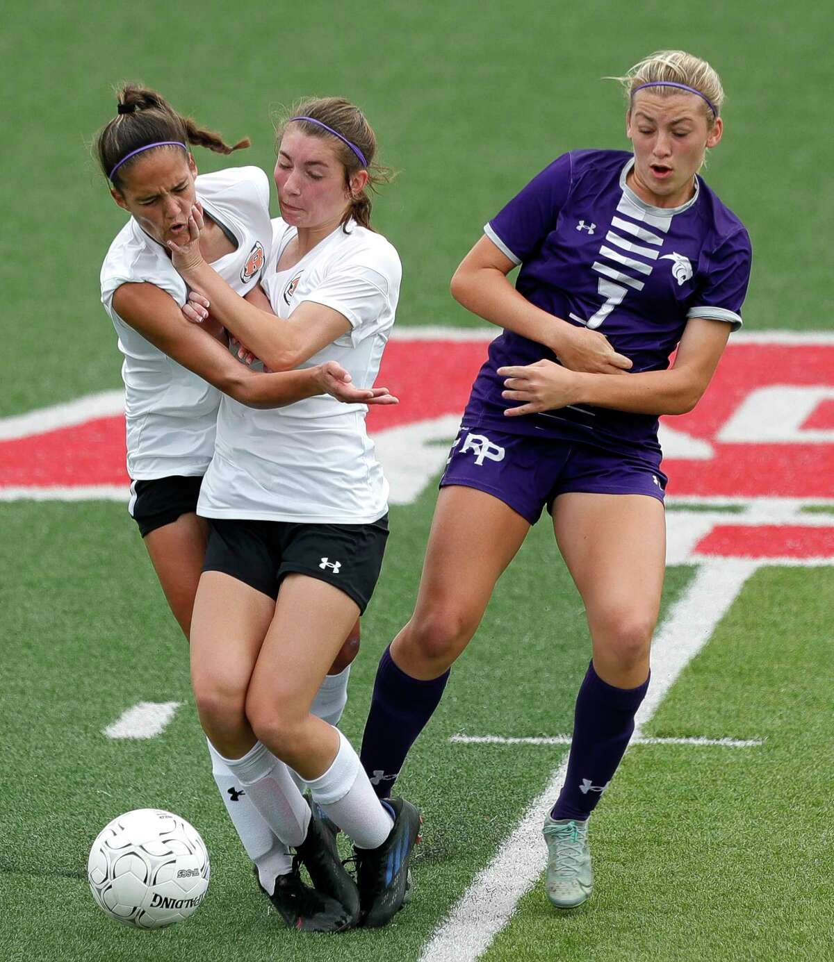 Rockwall defenders Ayla Garcia, left, and Savanna Clark collide while going for the ball against Fort Bend Ridge Point forward Zoe Main (7) in the second half of a Class 6A girls state semifinal match during the UIL State Soccer Championships, Friday, April 15, 2022, in Georgetown.