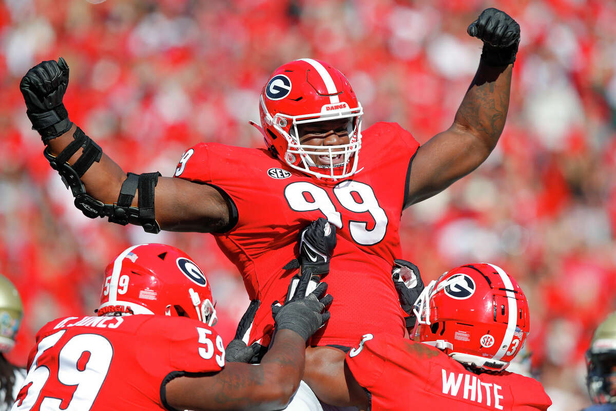 ATHENS, GA - NOVEMBER 20: Jordan Davis #99 of the Georgia Bulldogs reacts after rushing in for a touchdown during the first half against the Charleston Southern Buccaneers at Sanford Stadium on November 20, 2021 in Athens, Georgia. (Photo by Todd Kirkland/Getty Images)