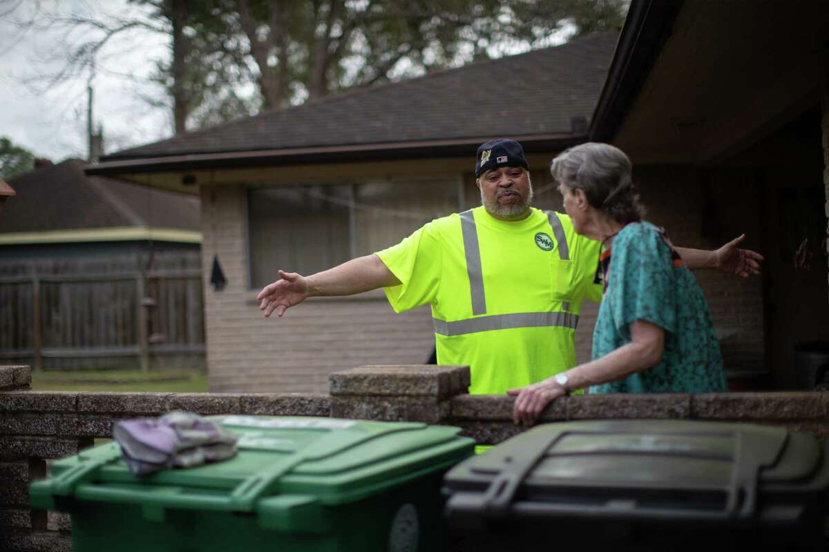 City of Houston Solid Waste Dept. trash truck driver Anthony Senegal, 56, embraces Westbury neighborhood resident Arlene Andrews, 92, before taking her trash bin to the truck, Tuesday, March 29, 2022, in Houston.
