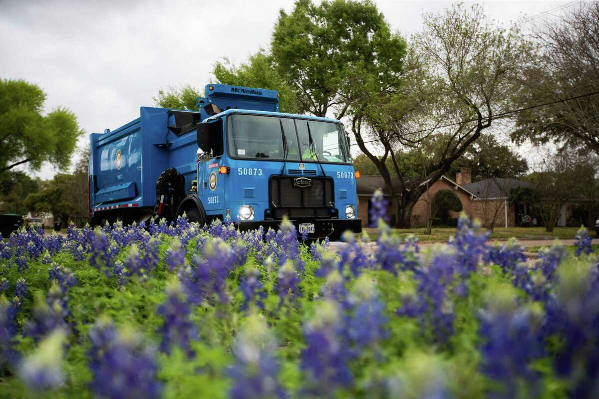 City of Houston Solid Waste Dept. trash truck driven by employee Anthony Senegal, 56, pass by blue bonnets at Westbury neighborhood while he picks up the solid waste in trash cans in the area during his rounds, Tuesday, March 29, 2022, in Houston.