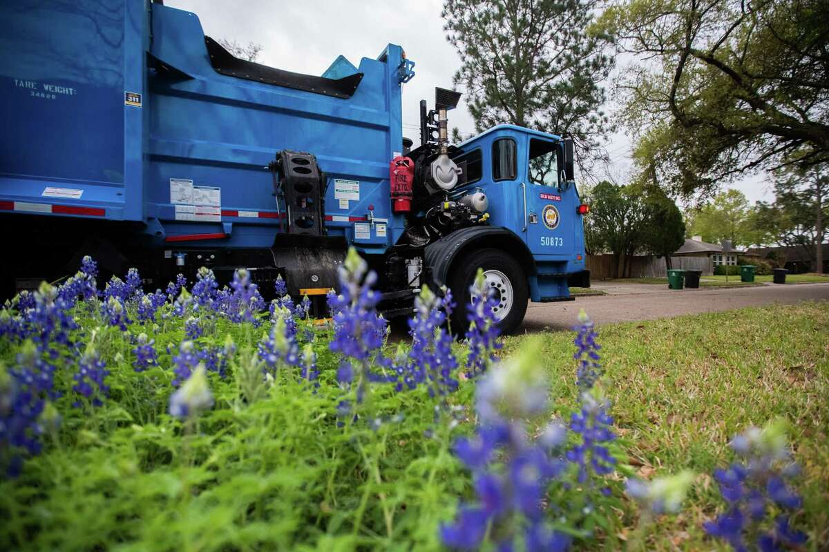 City of Houston Solid Waste Dept. trash truck driven by employee Anthony Senegal, 56, pass by blue bonnets at Westbury neighborhood while he picks up the solid waste in trash cans in the area during his rounds, Tuesday, March 29, 2022, in Houston.