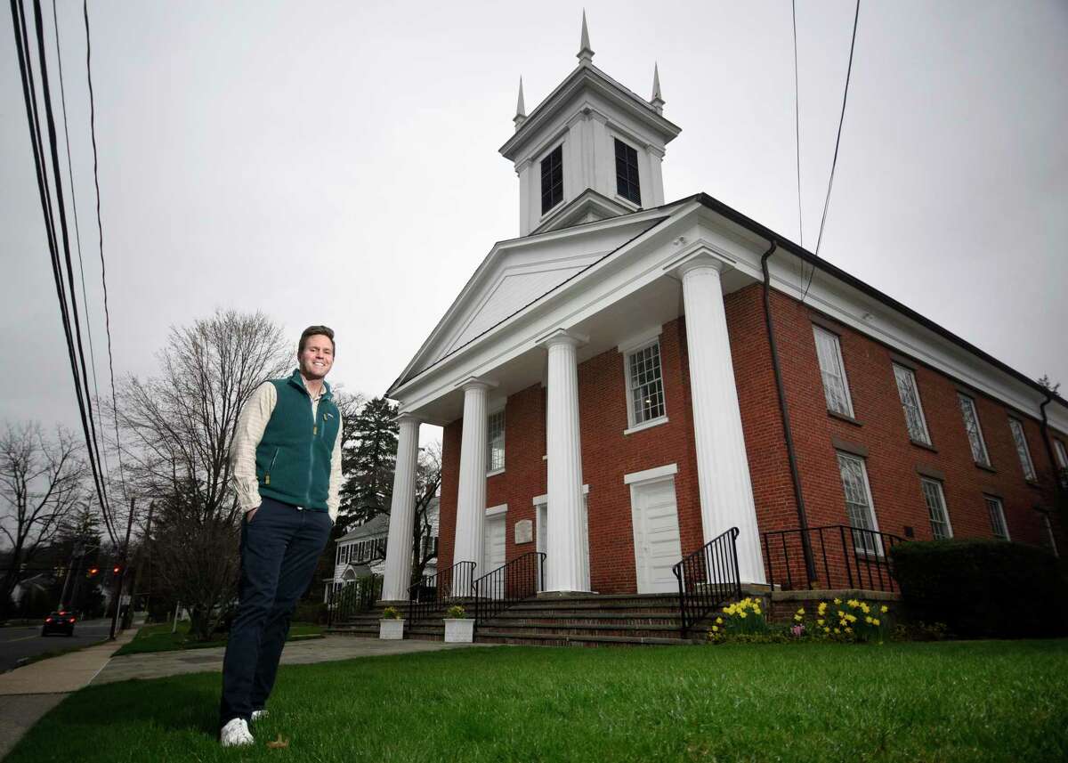 The Rev. Anthony Weisman poses at First Congregational Church in Darien on April 7. The Rev. Weisman took over as Senior Minister last month and is one of two openly gay clergy members in Darien.