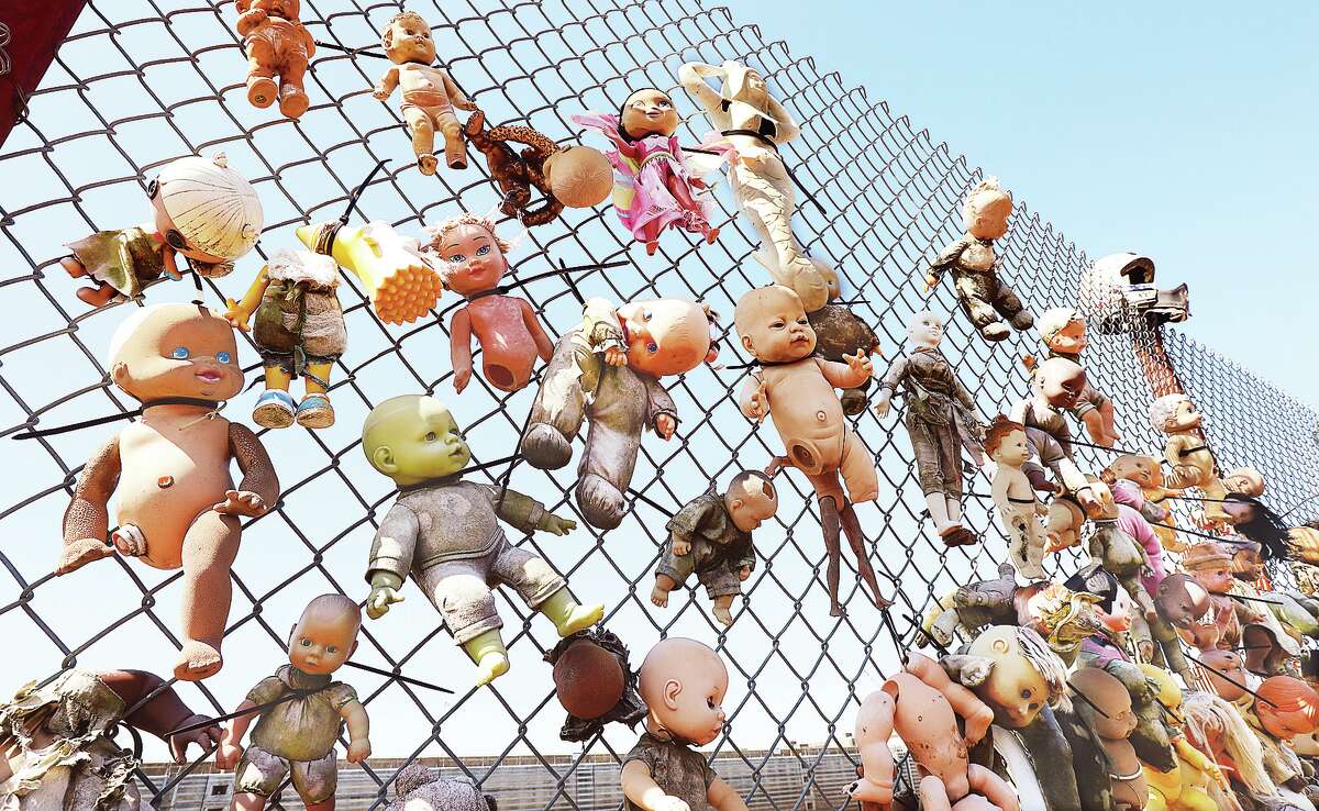 John Badman|The Telegraph The babies of the river hang on a chain-link wall Thursday aboard the barges of the Living Lands & Waters river cleanup docked at the Melvin Price Locks and Dam 26 in Alton. All of the dolls, and many more, were pulled from the river.
