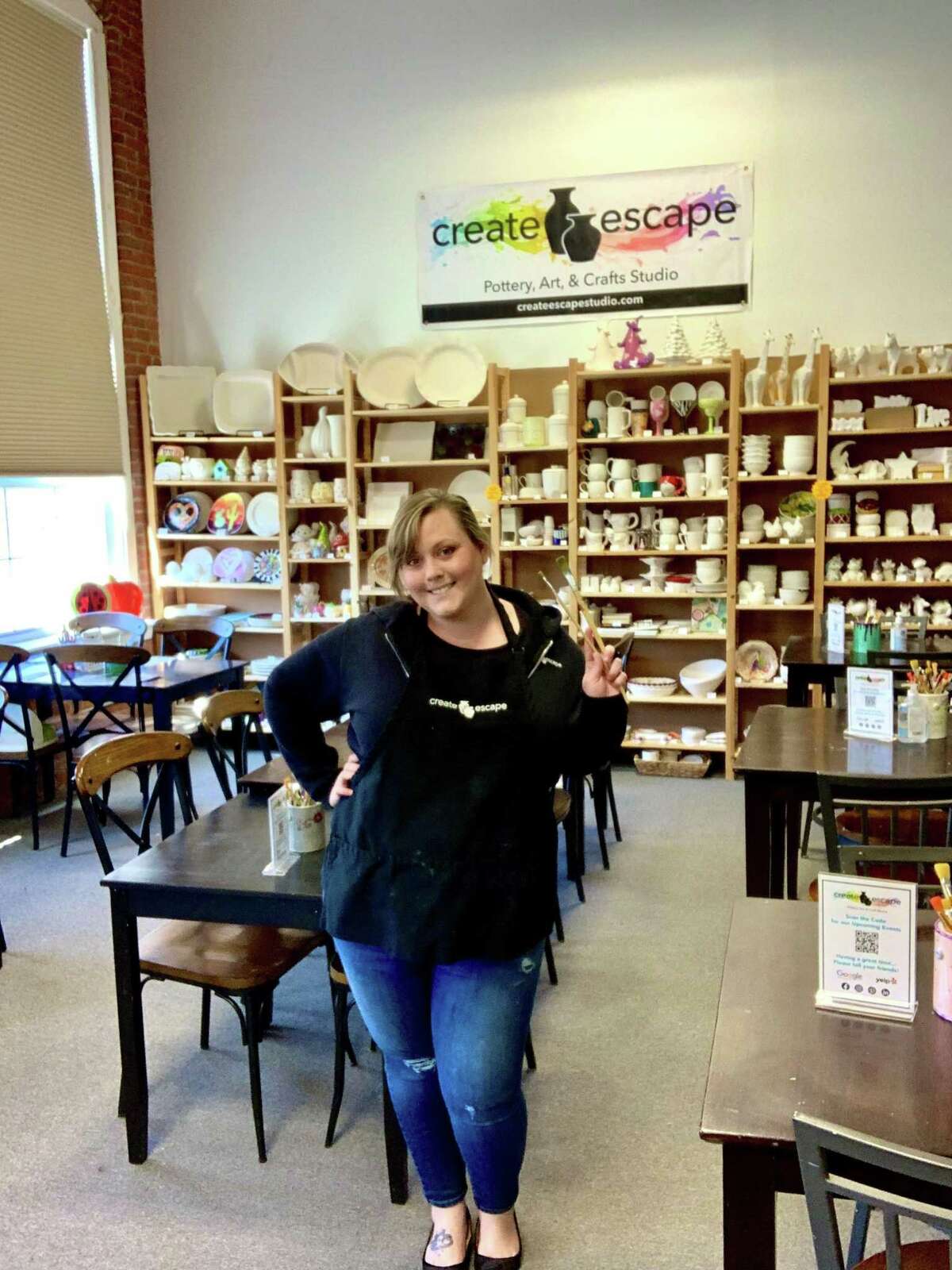 Create Escape Studio owner Heather Dann in her new studio in New Milford with the selection of pottery bisque in the background that customers can pick from to paint.