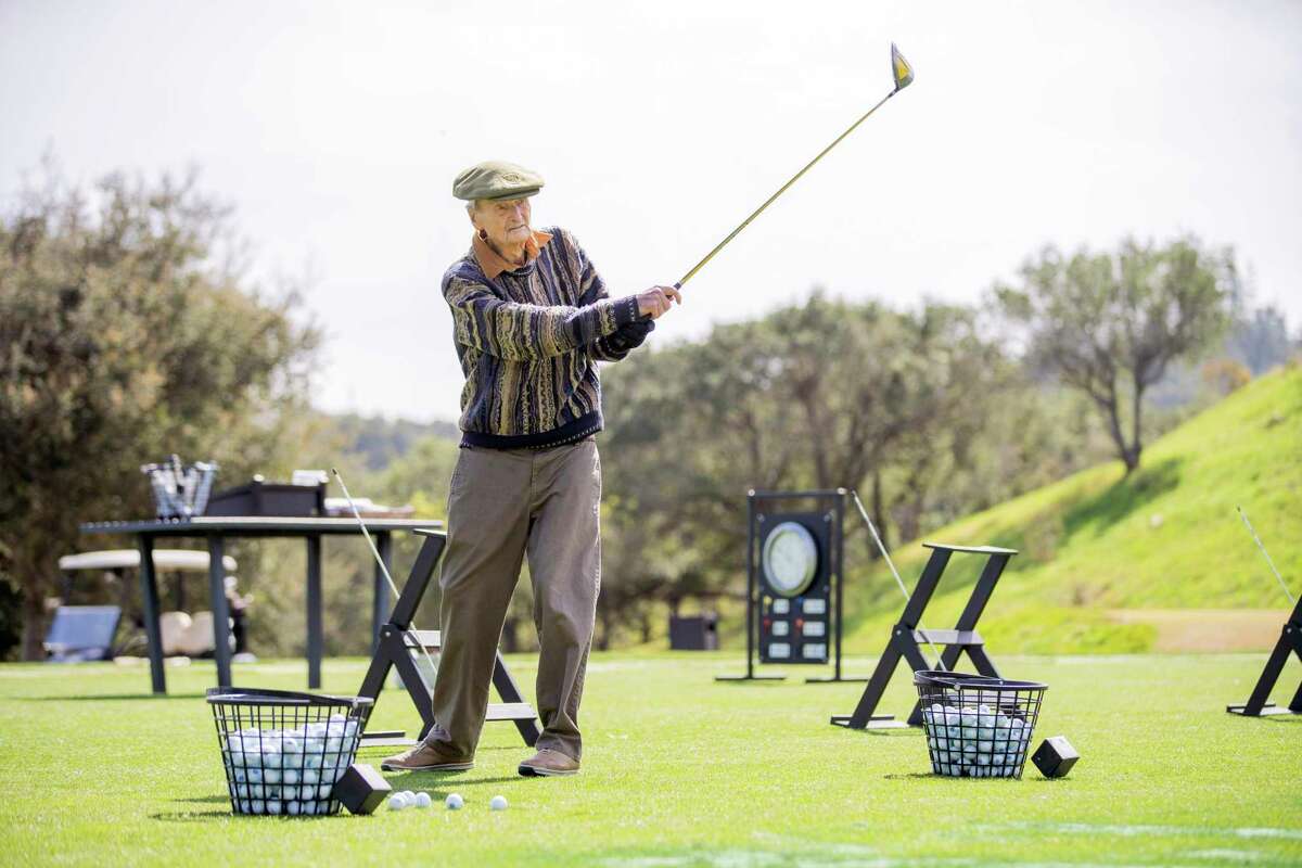 Bob Williams at Menlo Country Club’s driving range, Tuesday, March 1, 2022, in Woodside, Calif. Williams, 100, a centenarian, stays active and regularly plays golf.