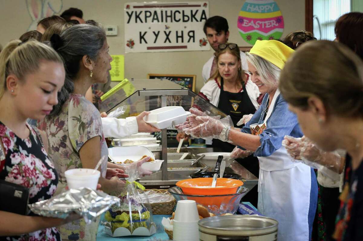 Sharon Nishtick, second from right, helps serve food during a Ukrainian Easter Bazaar on Sunday, April 10, 2022, at Pokrova Ukrainian Catholic Church in Houston.