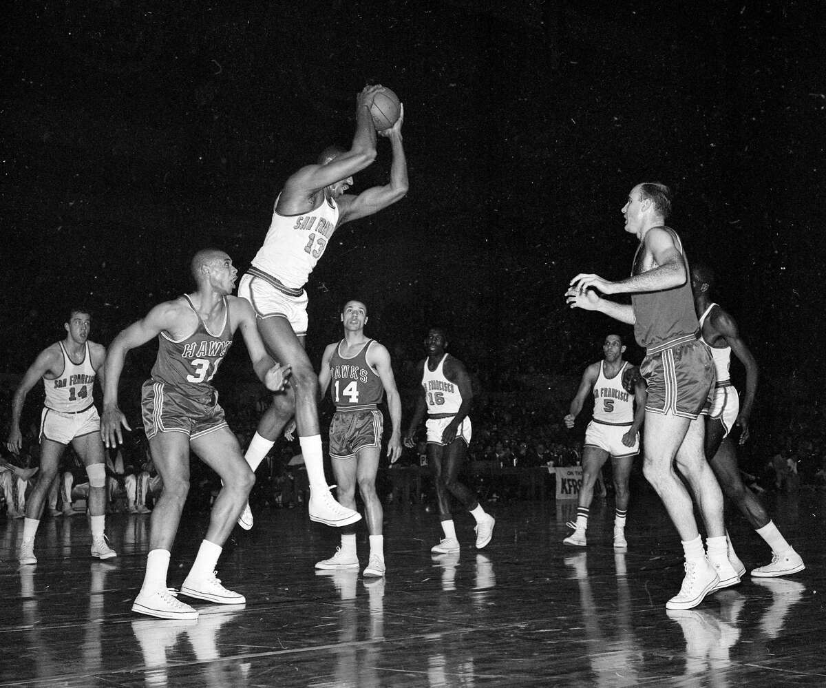 San Francisco Warriors center Wilt Chamberlain battles for a rebound with the Hawks' Zelmo Beatty in Game 2 of the Western Conference Finals April 3, 1964 at the Cow Palace.