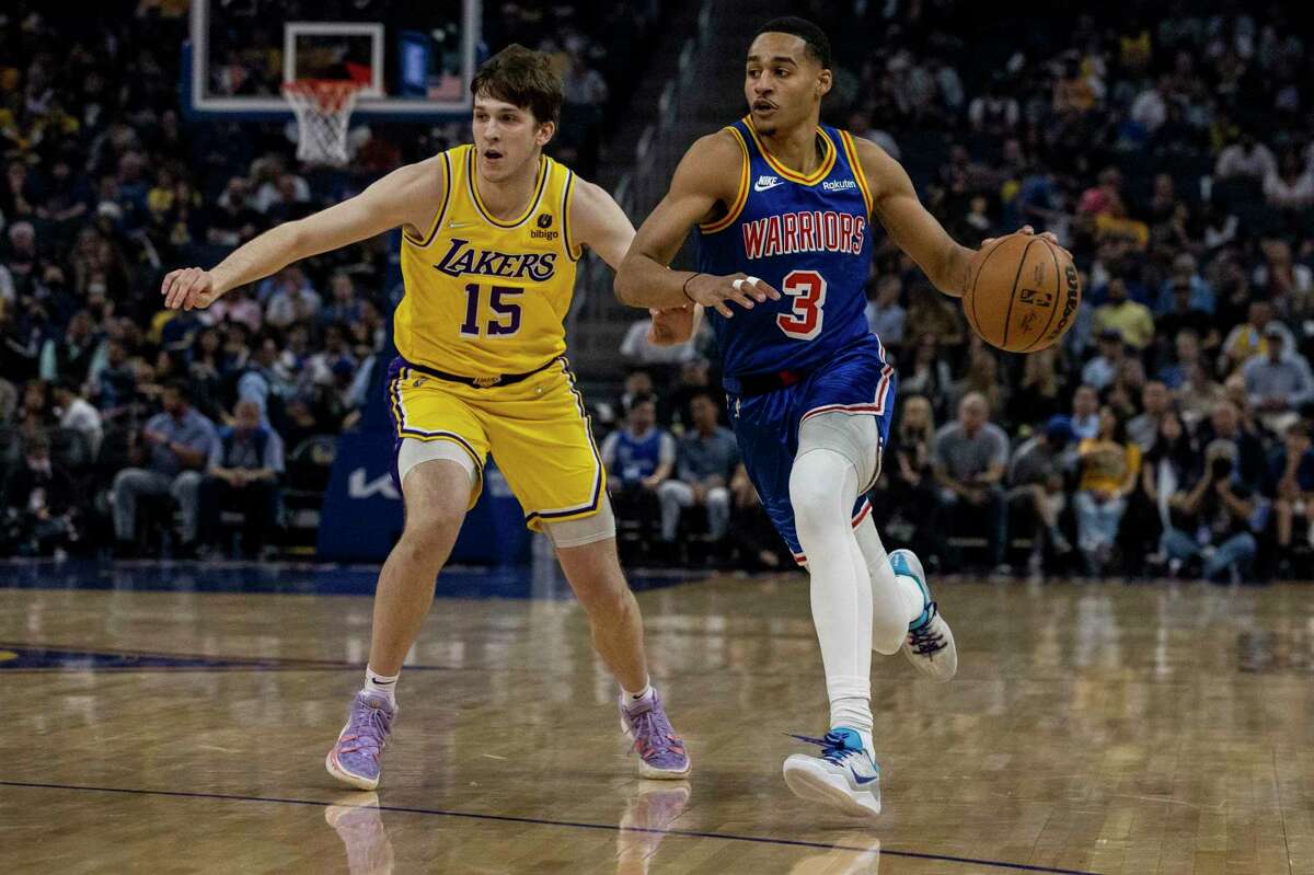 Golden State Warriors guard Jordan Poole drives the ball as Los Angeles Lakers guard Austin Reaves defends during the first quarter of their NBA basketball game in San Francisco, Calif. Thursday, April 7, 2022.