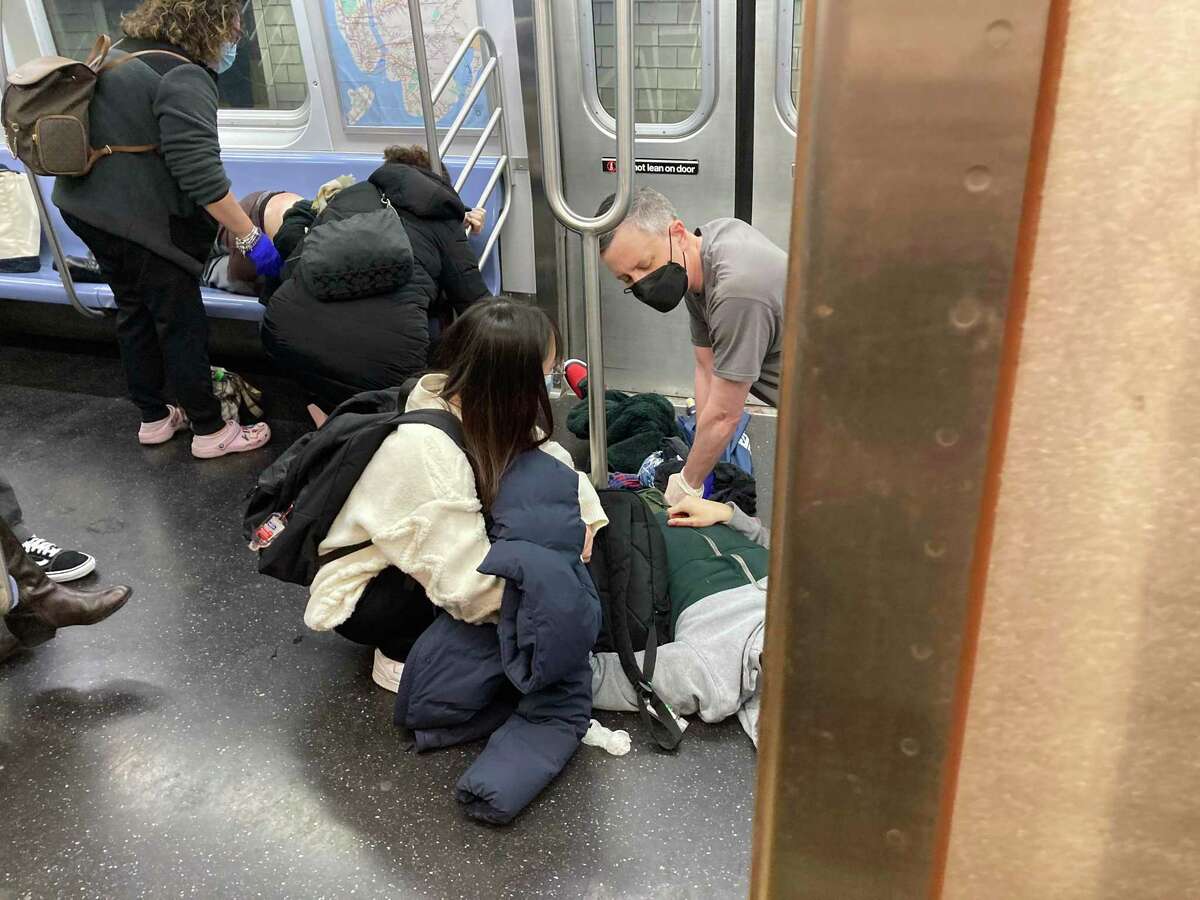Wounded commuters are given first aid after a shooting on a New York subway train on Tuesday morning, April 12, 2022. Multiple people were shot on the platform of a Brooklyn subway station during the Tuesday morning rush, officials said, a violent episode that heightened simmering fears about public safety as New York City struggles to recover from the pandemic. (Andrew Hinderaker/The New York Times)
