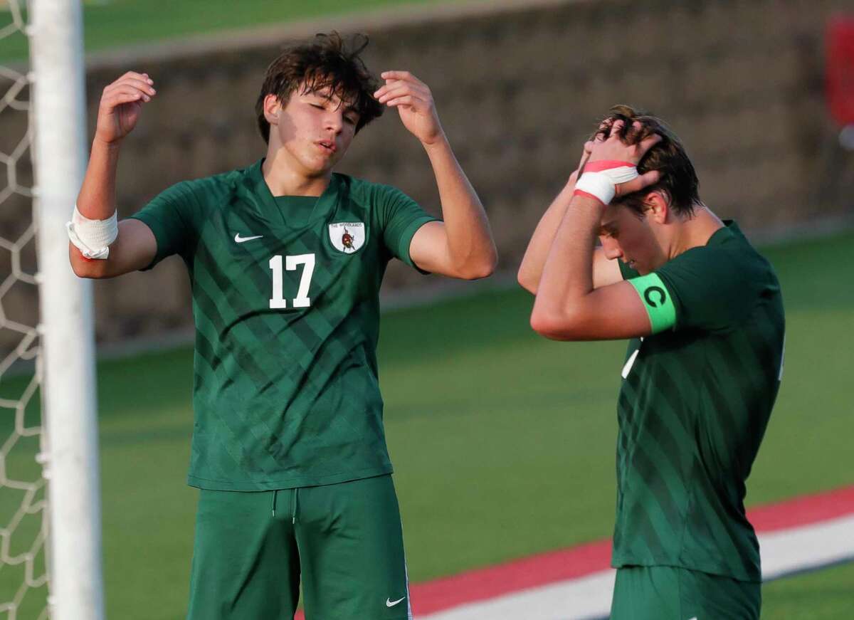 The Woodlands defender Andrew Hollenbach (17) throws his hands up beside teammate Mason Vezza (21) after a goal by Lake Travis forward Alex Bethke extends their lead to 3-0 in the second half of a Class 6A boys state semifinal match during the UIL State Soccer Championships, Friday, April 15, 2022, in Georgetown.