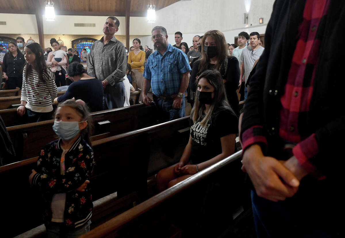 Members of the congregation observe the readings and prayers led by Fr. Urbano Ramirez as a server makes her way through the stations of the cross on Good Friday at Our Lady of Guadalupe Church in Port Arthur. Photo made Thursday April 15, 2022. Kim Brent/The Enterprise