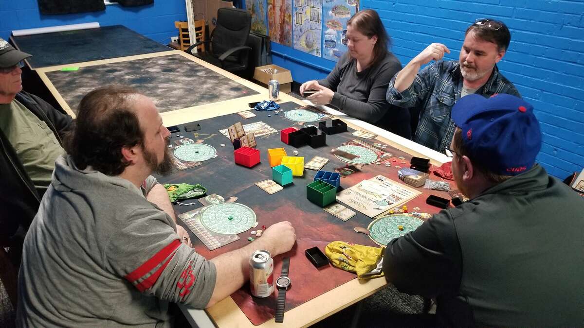 Players at an Atomic Squash game night at Otherside Games in Edwardsville getting ready to play the complex board game. 