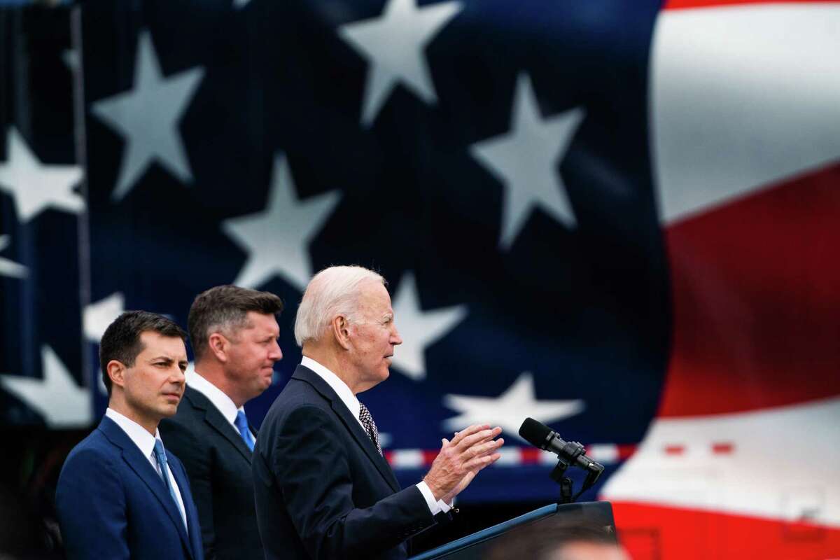 President Biden delivers remarks alongside Transportation Secretary Pete Buttigieg, left, last week.