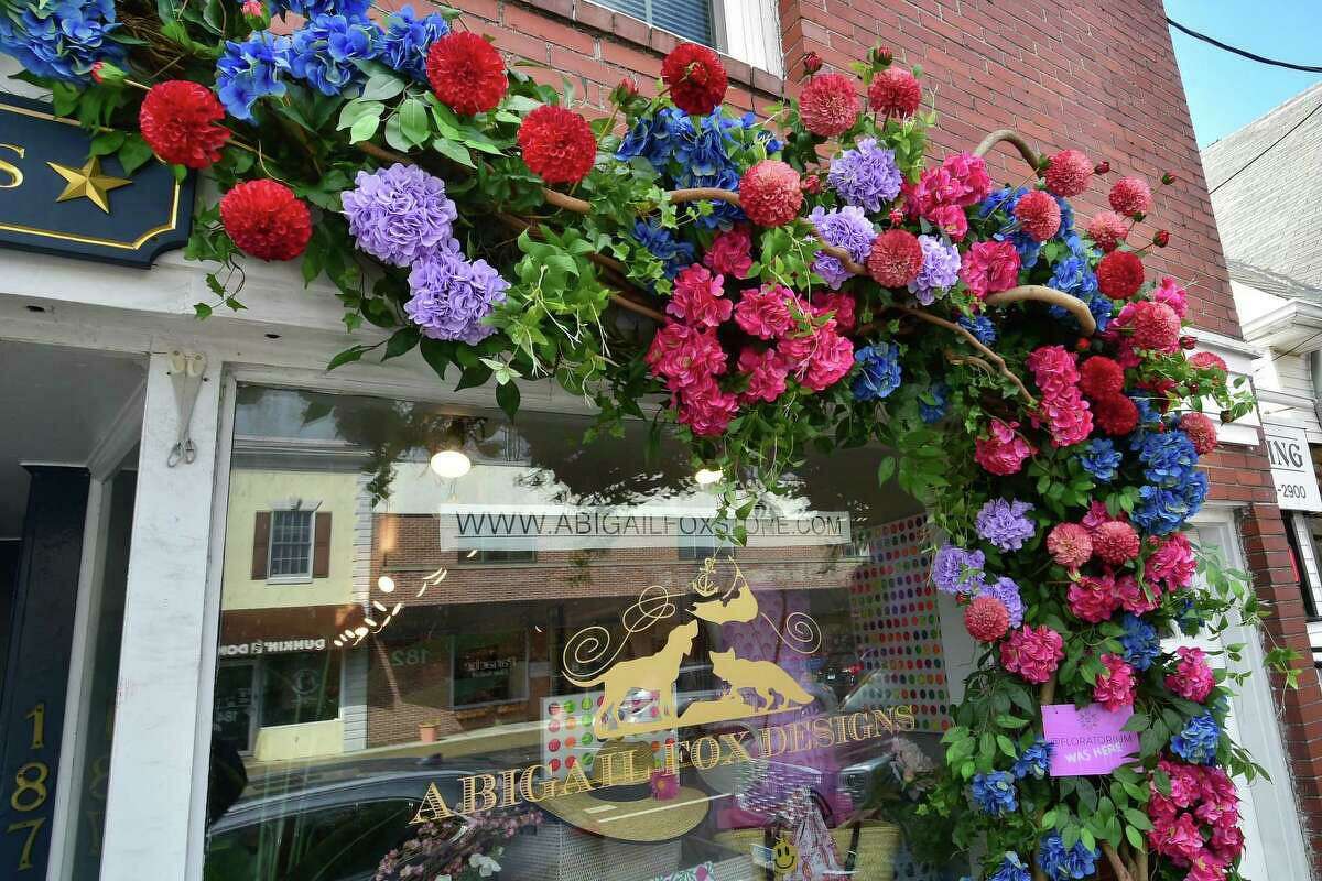 A floral display on the front of Abigail Fox Designs in Old Greenwich led the town to issue a violation and sparked a lively community discussion about signs.