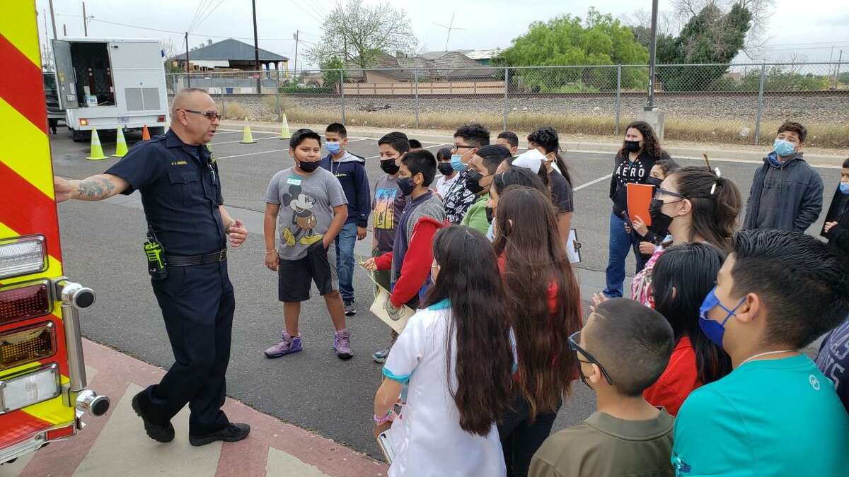 Laredo Fire Department Firefighter/Fire Inspector Jesus J. Guerra explains to J.C. Martin Elementary fifth graders how first responders use their equipment to protect property from a blaze.