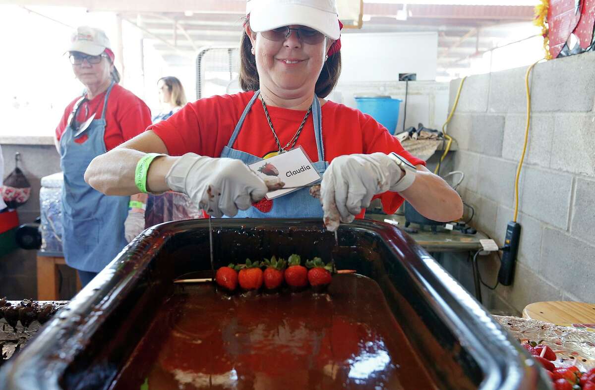 Claudia Amici-Tuckness dips Poteet strawberries into chocolate during the 2018 Poteet Strawberry Festival.