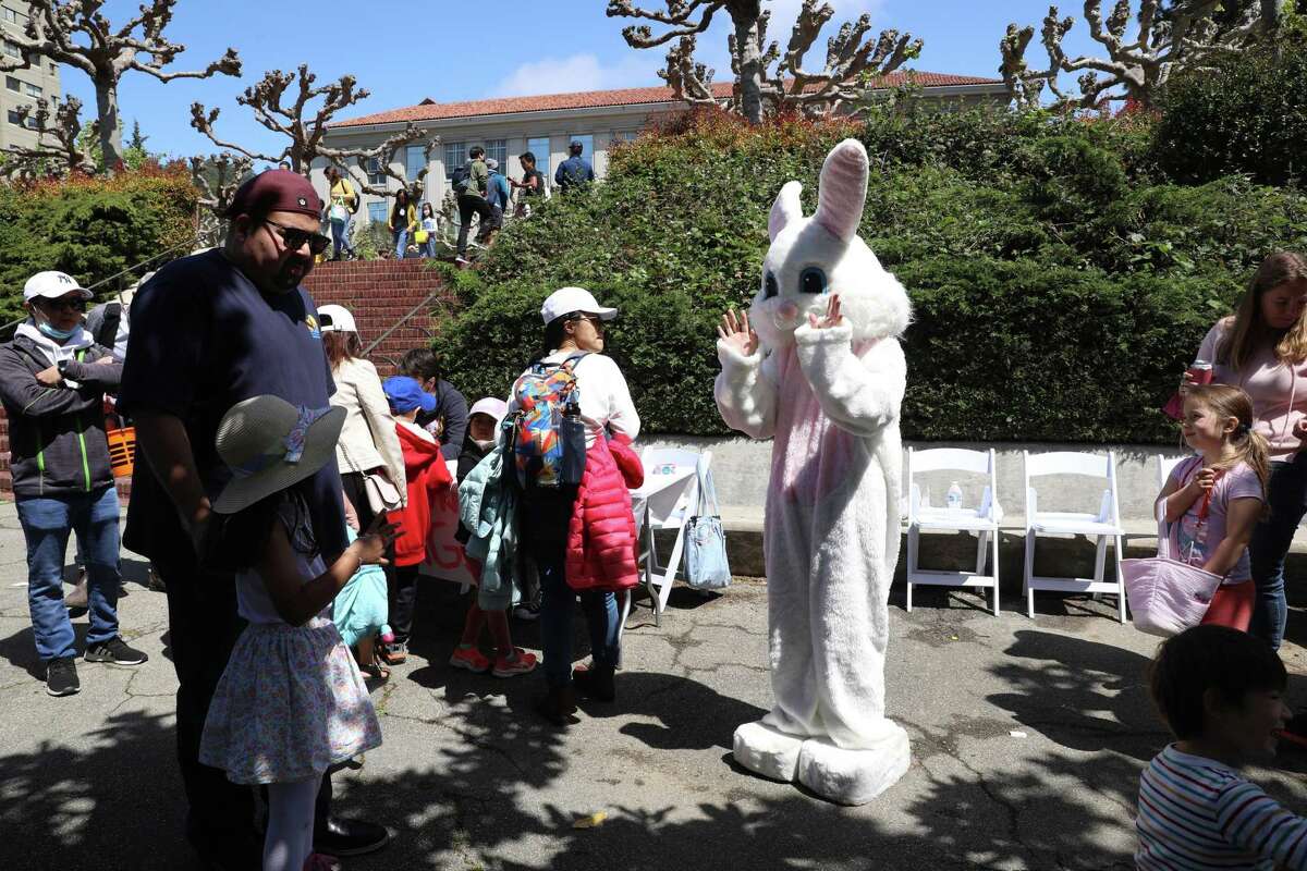 Dressed as an Easter bunny Berkeley Project volunteer Ames Lee, 19, of Pittsburg, greets families during the 28th annual Eggster event at UC Berkeley on Saturday, April 16, 2022, in Berkeley, Calif.