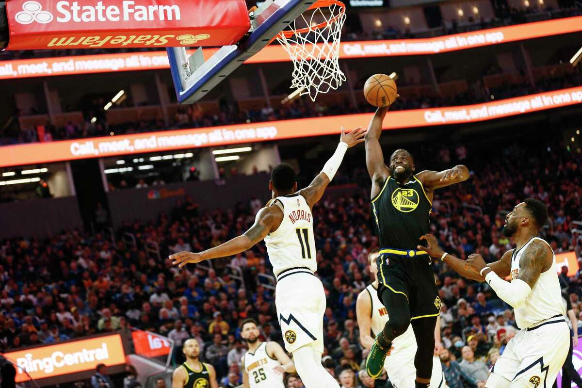 Golden State Warriors forward Draymond Green (23) dunks in the first half during Game 1 of the NBA first-round playoff series against the Denver Nuggets at Chase Center, Saturday, April 16, 2022, in San Francisco, Calif.