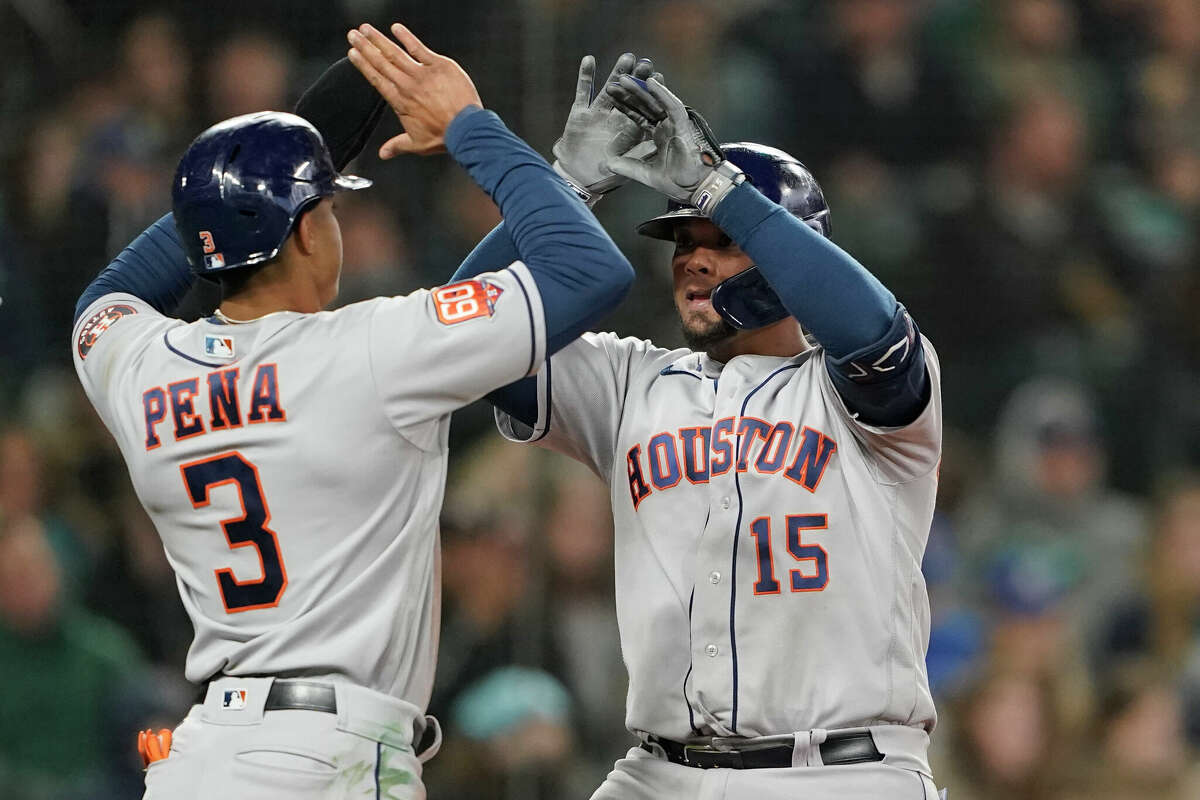 Houston Astros' Martin Maldonado, right, greets Jeremy Pena (3) after hitting a two-run home run to also score Pena during the fifth inning of a baseball game, Saturday, April 16, 2022, in Seattle. (AP Photo/Ted S. Warren)