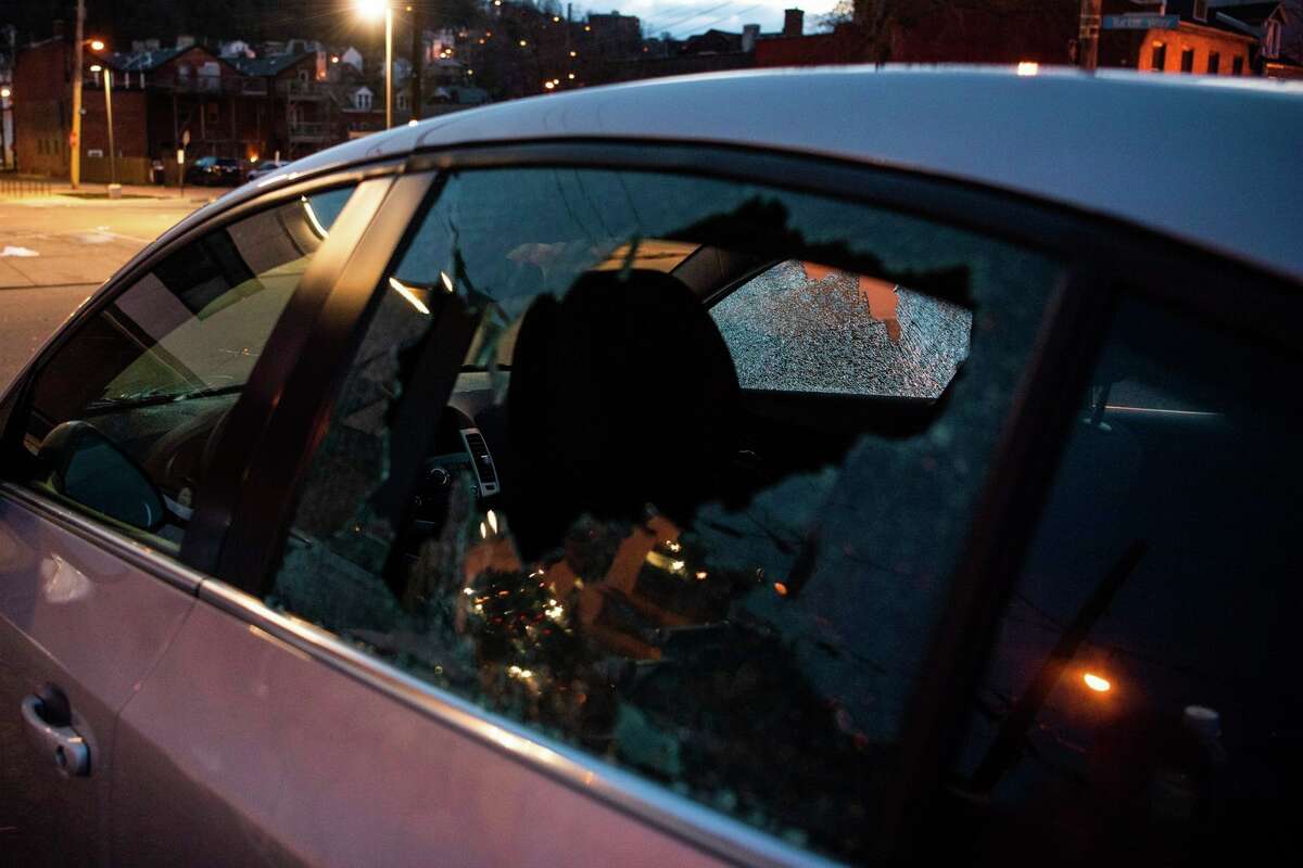A car window is shot out in the wake of a fatal shooting on Pittsburgh's North Side, Sunday, April 17, 2022. Pittsburgh police said in a release that the shooting happened around 12:30 a.m. at a short-term rental property with more than 200 people inside. (Shane Dunlap/Pittsburgh Tribune-Review via AP)