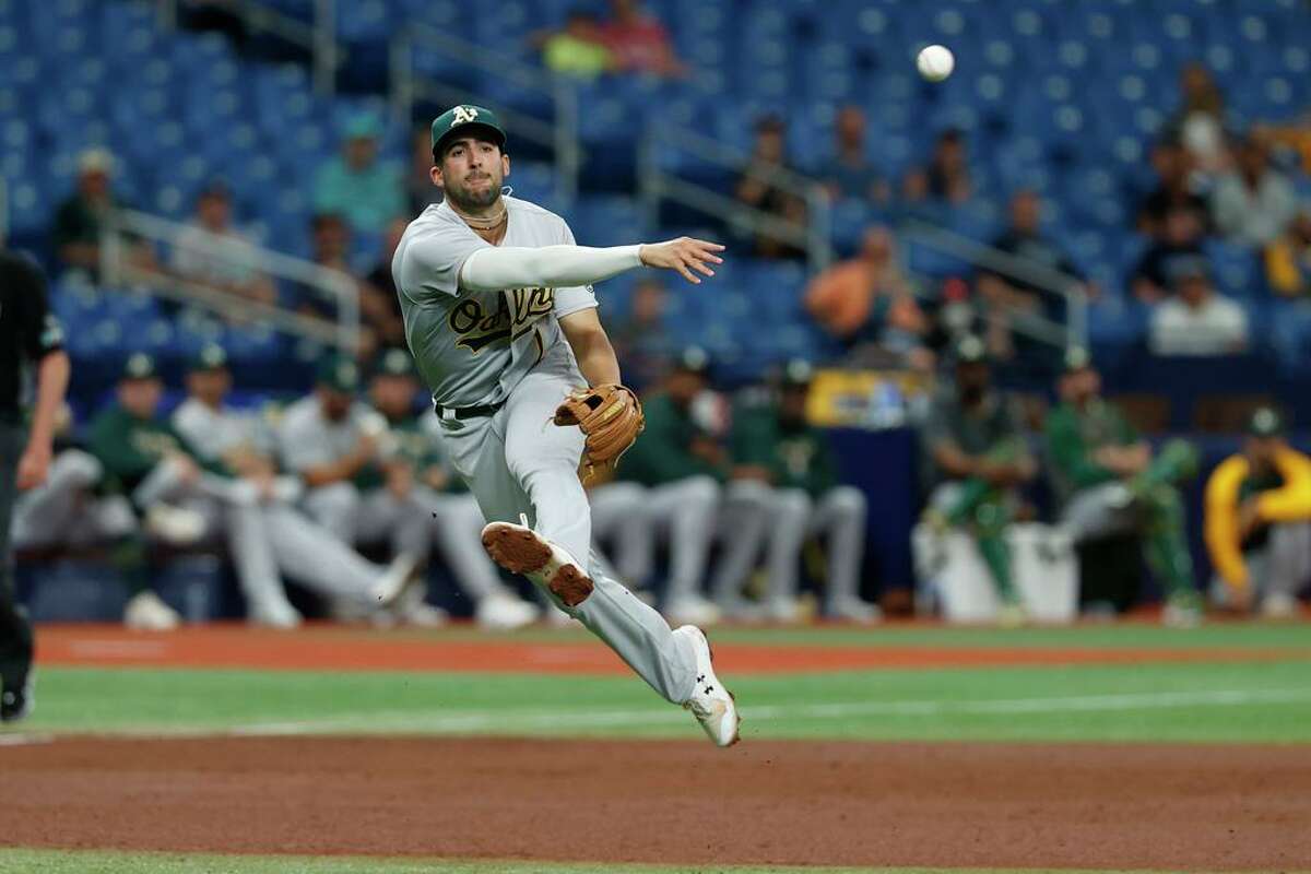 Oakland Athletics shortstop Kevin Smith throws to first base against the Tampa Bay Rays during the inning of a baseball game Thursday, April, 14, 2022, in St. Petersburg, Fla. (AP Photo/Scott Audette)