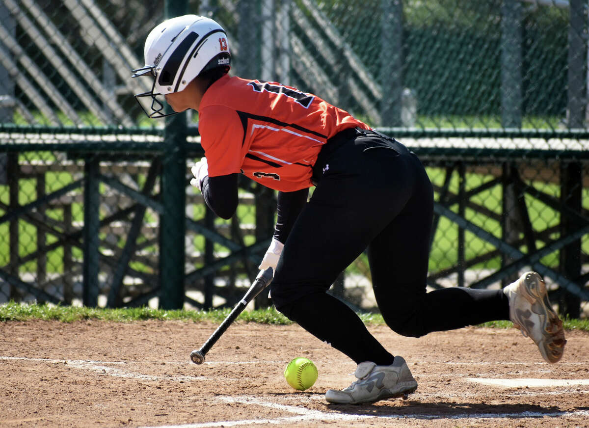 Edwardsville's Zoie Boyd drops down a bunt against Chatham Glenwood inside the District 7 Sports Complex in Edwardsville.