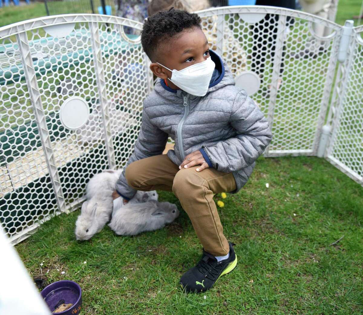Greenwich's Peter M., 6, pets bunnies at Second Congregational Church in Greenwich, Conn. Sunday, April 17, 2022. Following Easter services, children set out to hunt for candy-filled Easter eggs on the church lawn. There were also live bunnies and goats on hand for kids to pet.