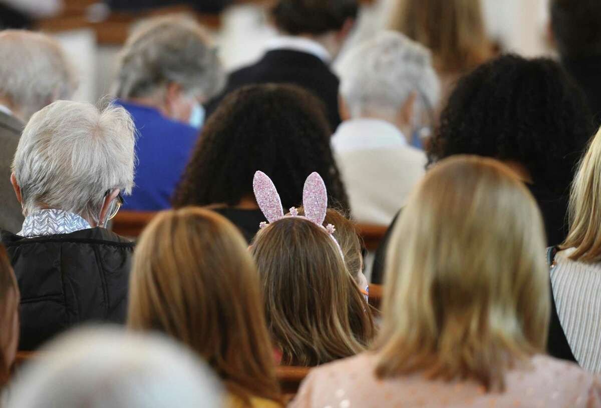 A young congregant wears bunny ears during the Easter Sunday Mass at St. John's Lutheran Church in Stamford, Conn. Sunday, April 17, 2022. Christians celebrated the resurrection of Jesus Christ with a variety of different Easter services, including sunrise and outdoor services, throughout town.