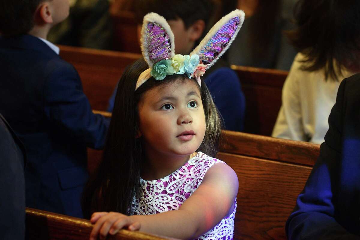 Teagan Bell, 5, of Easton, attends Easter Sunday Mass at Our Lady of the Assumption Church, in Fairfield, Conn. April 17, 2022. The church held the first services this weekend since being damaged by a fire last November.