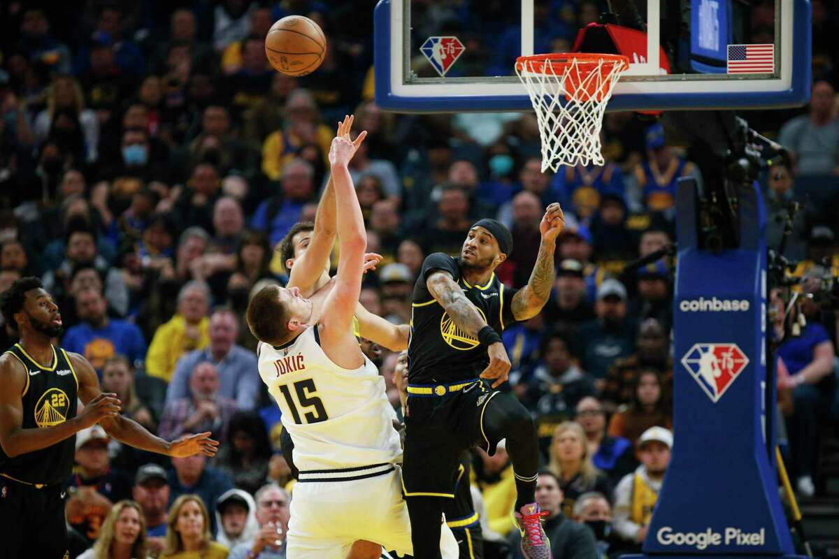 Golden State Warriors center Kevon Looney (5) guards Denver Nuggets center Nikola Jokic (15) in the first half during Game 1 of the NBA first-round playoff series against the Denver Nuggets at Chase Center, Saturday, April 16, 2022, in San Francisco, Calif.