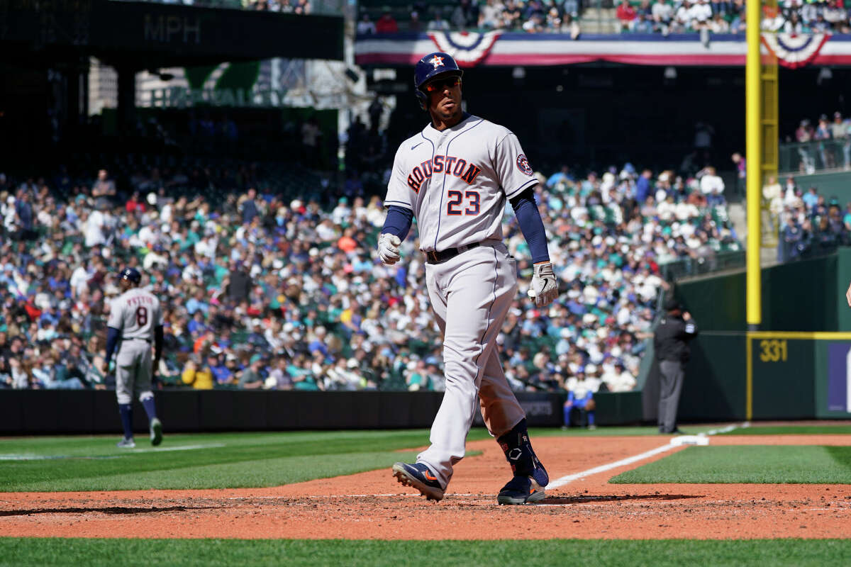 Houston Astros' Michael Brantley looks toward the Seattle Mariners dugout as he crosses the plate after his two-run home run broke up a no-hitter in progress from Seattle Mariners starting pitcher Matt Brash during the sixth inning of a baseball game, Sunday, April 17, 2022, in Seattle. (AP Photo/Ted S. Warren)