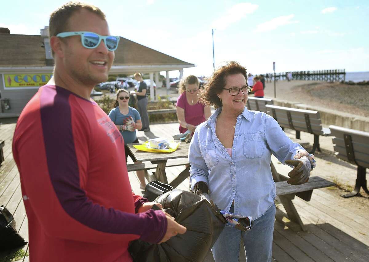 Tor Blackstad, of Milford, and State Rep. Kathy Kennedy participate in a beach clean-up at Gulf Beach in Milford, Conn. on Sunday, September 26, 20i21.