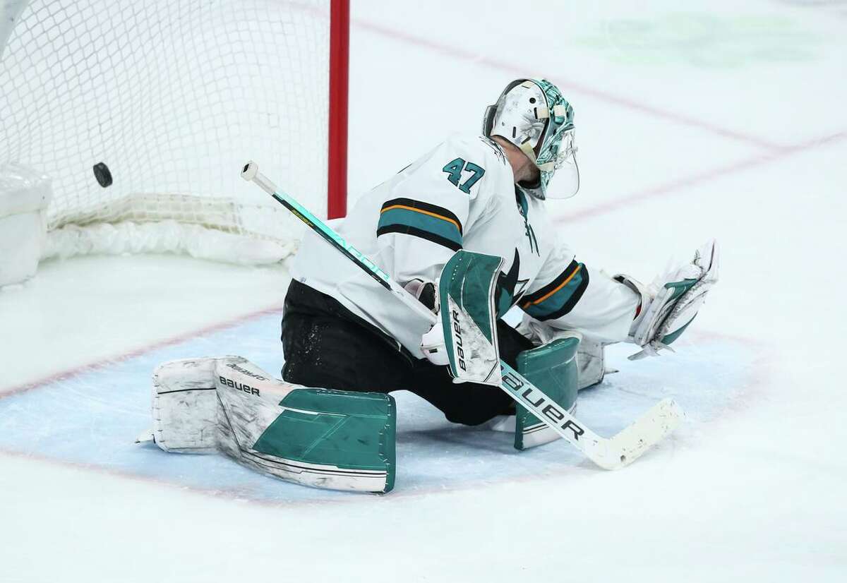 A puck tipped by Jared Spurgeon of the Minnesota Wild gets past James Reimer #47 of the San Jose Sharks in overtime at Xcel Energy Center on April 17, 2022 in St Paul, Minnesota. The Wild defeated the Sharks 5-4 and clinched a berth to the Stanley Cup Playoffs. (Photo by David Berding/Getty Images)