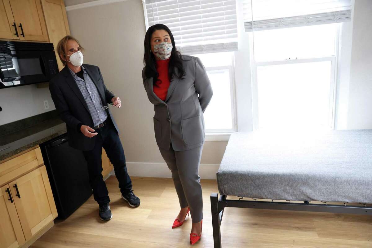 Randy Shaw, Executive Director of the Tenderloin Housing Clinic, and San Francisco Mayor London Breed tour a room at The Garland, a new city-owned supportive housing site in The Tenderloin in San Francisco, Calif, on Wednesday, April 13, 2022.