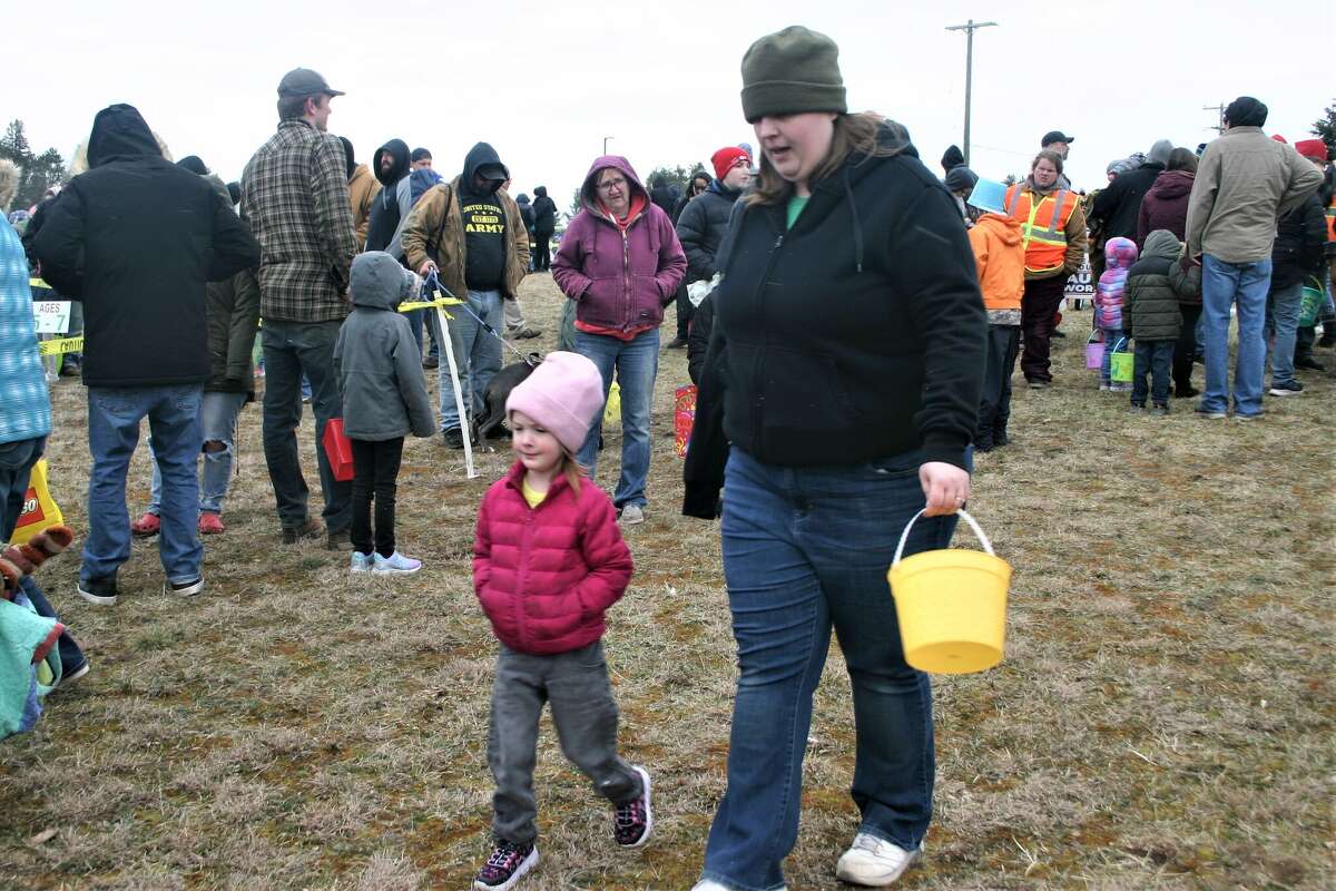 Cold, wind and even a little snow didn't keep the crowds from descending on the Evart High School grounds for the annual Easter Egg Drop. Weather prevented the helicopter from dropping eggs, but that didn't dampen the spirt as kids of all ages scrambled to collect thousands of candy-filled eggs scattered about the ground.
