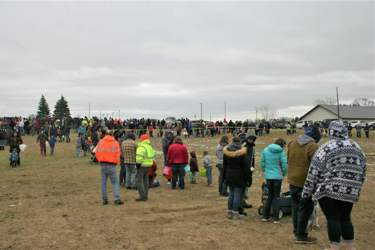 Cold, wind and even a little snow didn't keep the crowds from descending on the Evart High School grounds for the annual Easter Egg Drop. Weather prevented the helicopter from dropping eggs, but that didn't dampen the spirt as kids of all ages scrambled to collect thousands of candy-filled eggs scattered about the ground.