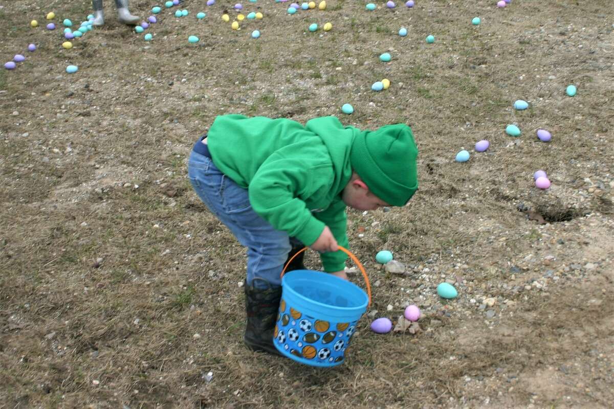 Cold, wind and even a little snow didn't keep the crowds from descending on the Evart High School grounds for the annual Easter Egg Drop. Weather prevented the helicopter from dropping eggs, but that didn't dampen the spirt as kids of all ages scrambled to collect thousands of candy-filled eggs scattered about the ground.